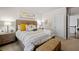 Inviting bedroom featuring decorative pillows, natural lighting, and an adjacent sitting area at 4590 Gablestone Xing, Hoschton, GA 30548