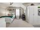 Bedroom with a full-sized bed, built in shelving, ceiling fan, and carpet flooring at 4590 Gablestone Xing, Hoschton, GA 30548
