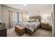 Serene bedroom with neutral tones, a window view, and cozy furnishings at 4590 Gablestone Xing, Hoschton, GA 30548