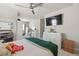 Bedroom with a full-sized bed, television, ceiling fan, and built in shelving at 4590 Gablestone Xing, Hoschton, GA 30548