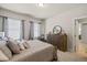 Bedroom with a full-sized bed, dresser, two windows, and carpet flooring at 4590 Gablestone Xing, Hoschton, GA 30548