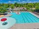 Community pool with a slide, mushroom water feature, and a covered pavilion for relaxation at 4590 Gablestone Xing, Hoschton, GA 30548