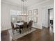 Modern dining room with natural light, stylish chandelier and seating for six at 4590 Gablestone Xing, Hoschton, GA 30548
