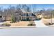 Exterior view of traditional-style home with brick and stone accents and landscaped yard at 4590 Gablestone Xing, Hoschton, GA 30548