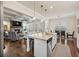 Open layout featuring a kitchen with island seating flowing into the living room at 4590 Gablestone Xing, Hoschton, GA 30548