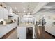 Modern kitchen with a large island, stainless appliances, and white cabinetry at 4590 Gablestone Xing, Hoschton, GA 30548