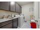 Laundry room with a stainless steel sink, granite countertop, washer, and dryer at 4590 Gablestone Xing, Hoschton, GA 30548