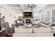 Inviting living room with a stone fireplace, coffered ceilings, and plenty of natural light at 4590 Gablestone Xing, Hoschton, GA 30548
