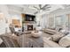 Living room features a stone fireplace, large windows, and an open layout at 4590 Gablestone Xing, Hoschton, GA 30548
