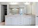 This bathroom features a long vanity with double sinks and views to the shower and closet at 4590 Gablestone Xing, Hoschton, GA 30548