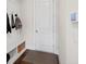 Mudroom with a built-in bench, coat hooks and storage cubbies for organization at 4590 Gablestone Xing, Hoschton, GA 30548