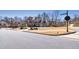 Street view of traditional home with large lawn and Cobblestone Crossing street sign at 4590 Gablestone Xing, Hoschton, GA 30548