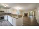 Open-concept kitchen with stainless steel appliances and sleek countertops overlooks the living area at 2958 Stonecrest Ln, Lithonia, GA 30038