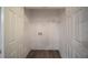 Bright laundry closet with white walls, wood-look flooring, and hookups for a washer and dryer at 2958 Stonecrest Ln, Lithonia, GA 30038