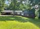 Two-story home with brick foundation, attached carport and a well-manicured lawn at 3478 Grant Nw Dr, Kennesaw, GA 30144