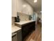 White kitchen cabinets and island featuring open metal and wood shelving at 3478 Grant Nw Dr, Kennesaw, GA 30144