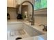 Close-up of the modern kitchen faucet and deep sink with quartz countertops at 3478 Grant Nw Dr, Kennesaw, GA 30144