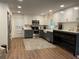 This kitchen features white and gray cabinetry, stainless steel appliances, and hardwood floors at 3478 Grant Nw Dr, Kennesaw, GA 30144