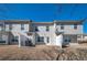 Backyard view of townhomes featuring gray siding, small patios, and a shared lawn area at 402 Whippet St, Union City, GA 30291