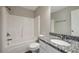 This bathroom boasts a granite countertop and white cabinets, complemented by a tub and shower at 402 Whippet St, Union City, GA 30291