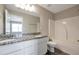 Bathroom featuring double sink vanity with granite countertop and tub/shower combination at 402 Whippet St, Union City, GA 30291