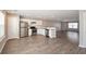 Open-concept kitchen with white cabinetry, stainless steel appliances, and spacious gray countertops at 402 Whippet St, Union City, GA 30291
