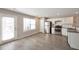 Bright kitchen features stainless appliances, white cabinets, gray counters, and sleek wood flooring at 402 Whippet St, Union City, GA 30291