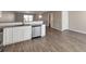 Kitchen area boasts stainless dishwasher, granite countertops, and grey flooring at 402 Whippet St, Union City, GA 30291
