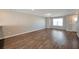 Living room featuring hardwood floors, neutral paint, large window, and stairs to the second floor at 402 Whippet St, Union City, GA 30291