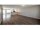 Spacious living room featuring hardwood flooring, neutral paint, and open floorplan to the kitchen at 402 Whippet St, Union City, GA 30291