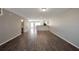 Expansive living room with hardwood flooring, neutral paint, and entry view to the bathroom at 402 Whippet St, Union City, GA 30291