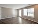 Inviting living room with a large window, door to back yard, and stylish gray flooring at 402 Whippet St, Union City, GA 30291