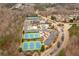 A high aerial view showcases community amenities, including multiple tennis courts and a swimming pool at 510 Pinchot Way, Woodstock, GA 30188