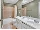 Bathroom featuring a double sink vanity and shower over tub with tiled surround at 510 Pinchot Way, Woodstock, GA 30188