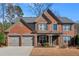 Charming two-story brick home with a well-manicured lawn and a three-car garage at 510 Pinchot Way, Woodstock, GA 30188