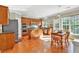 Bright kitchen with an island, wooden cabinets, stainless steel appliances, and a breakfast table by the window at 510 Pinchot Way, Woodstock, GA 30188