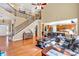Spacious living room with a staircase, hardwood floors, and an open view to the kitchen at 510 Pinchot Way, Woodstock, GA 30188