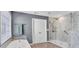 This bathroom boasts a soaking tub, marble shower, and a neutral color palette at 510 Pinchot Way, Woodstock, GA 30188