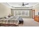 This main bedroom boasts a large bank of windows and a tray ceiling with a ceiling fan at 510 Pinchot Way, Woodstock, GA 30188