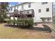 Backyard featuring a two-story deck, landscaping, and a gravel path at 6268 Braidwood Nw Run, Acworth, GA 30101