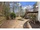 Landscaped backyard featuring a stone pathway and stairs to the deck above at 6268 Braidwood Nw Run, Acworth, GA 30101