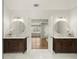 Bathroom featuring dual sinks with dark wood cabinets and modern lighting at 6268 Braidwood Nw Run, Acworth, GA 30101