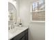Well-lit bathroom with modern vanity, countertops and a window providing plenty of natural light at 6268 Braidwood Nw Run, Acworth, GA 30101