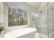 Bathroom featuring a soaking tub and glass enclosed shower at 6268 Braidwood Nw Run, Acworth, GA 30101