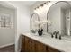 Bathroom featuring a double vanity, two mirrors, granite countertops, and modern lighting at 6268 Braidwood Nw Run, Acworth, GA 30101