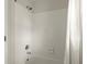 Bathroom featuring a shower with white tiles and silver fixtures, plus a white shower curtain at 6268 Braidwood Nw Run, Acworth, GA 30101