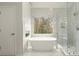 Luxurious bathroom featuring a soaking tub and a glass enclosed shower at 6268 Braidwood Nw Run, Acworth, GA 30101