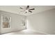 Bright bedroom featuring plush carpet, a ceiling fan and two windows with natural light at 6268 Braidwood Nw Run, Acworth, GA 30101