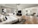 Bright bedroom suite featuring a ceiling fan, hardwood floors, and adjacent living area at 6268 Braidwood Nw Run, Acworth, GA 30101