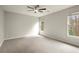 Bedroom featuring plush carpet, a ceiling fan, and two windows providing ample light at 6268 Braidwood Nw Run, Acworth, GA 30101